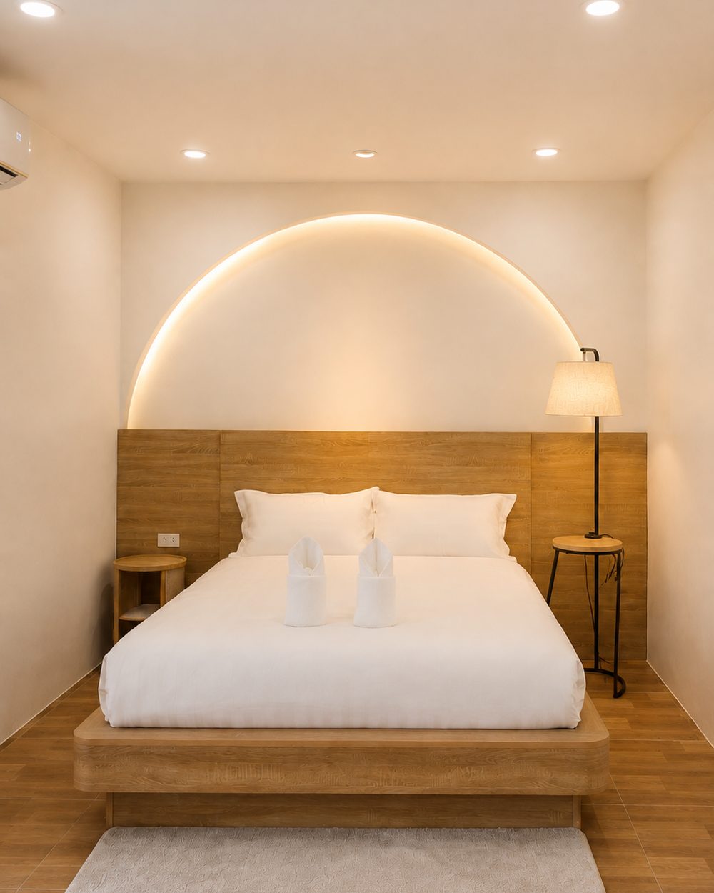 Primary bedroom with a backlit arch above the headboard